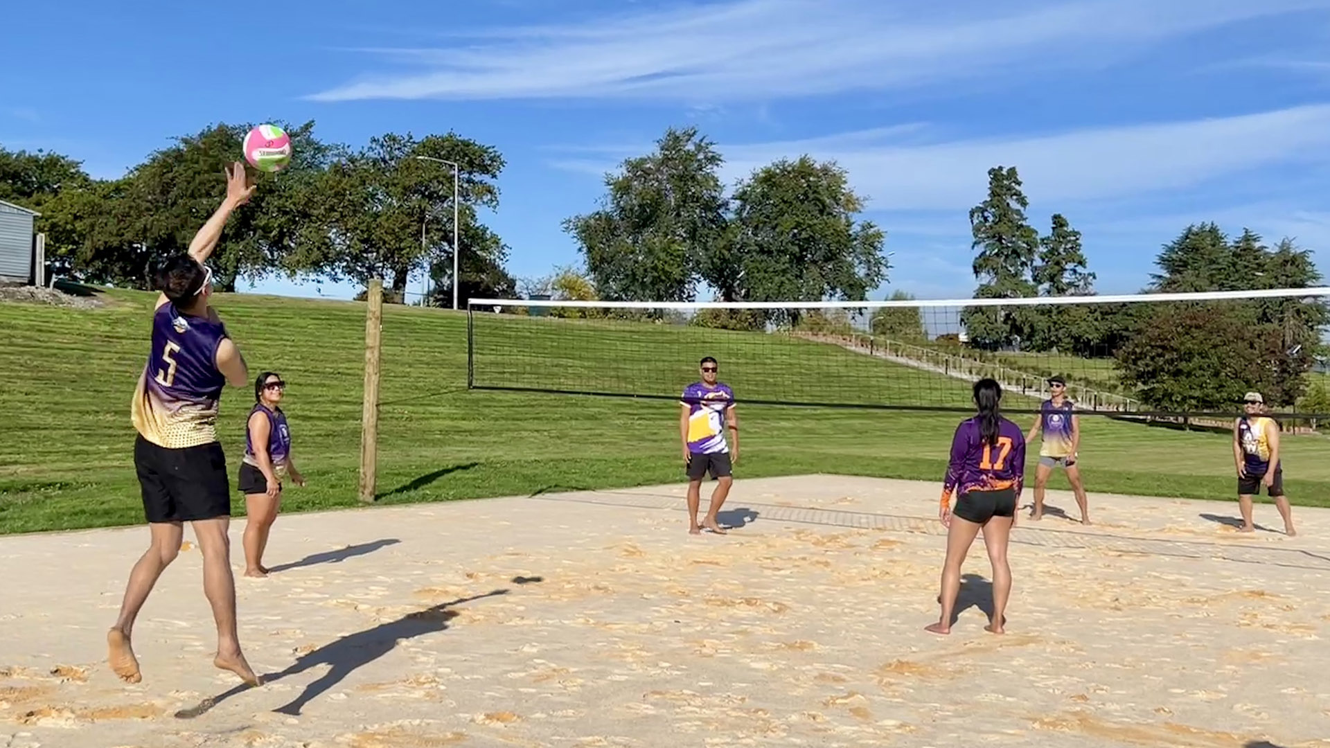 The volleyball team play on the sand court