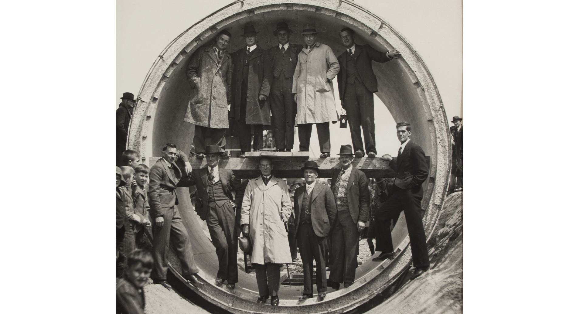 Men standing in large concrete pipe
