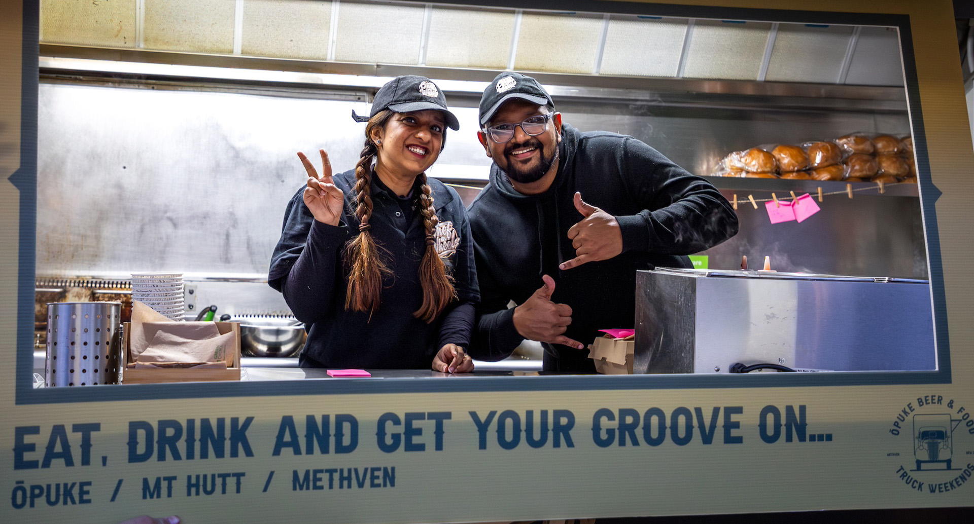 Two people in a food caravan